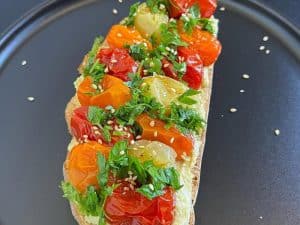 Delicious Hummus Toast with Roasted Cherry Tomatoes - Try It Now!