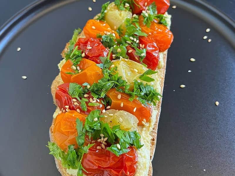 Delicious Hummus Toast with Roasted Cherry Tomatoes - Try It Now!